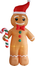 Tall gingerbread man inflatable in a Santa hat and red bow tie holding a candy cane