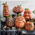 Group of pumpkin props with realistic sculpted faces on a shelf with skeleton hands and fake mice