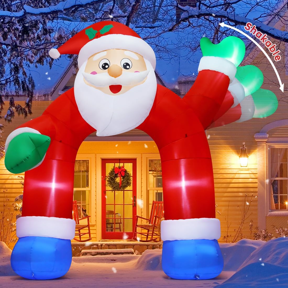 Santa-shaped archway inflatable with a waving mitten over a front walk