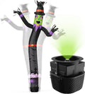 Black witch tube man inflatable with a green face and pointed hat beside a blower casting green light