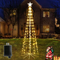 Warm white LED cone Christmas tree with a star on a lawn at night with an adapter shown