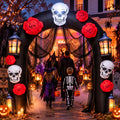 Black Halloween arch inflatable with a white skull, red roses and lanterns over a path with kids in costume