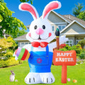Tall white Easter bunny inflatable in overalls holding a painted egg and brush beside a Happy Easter sign