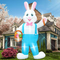 Tall white Easter bunny inflatable in blue overalls holding an egg basket in front of a house
