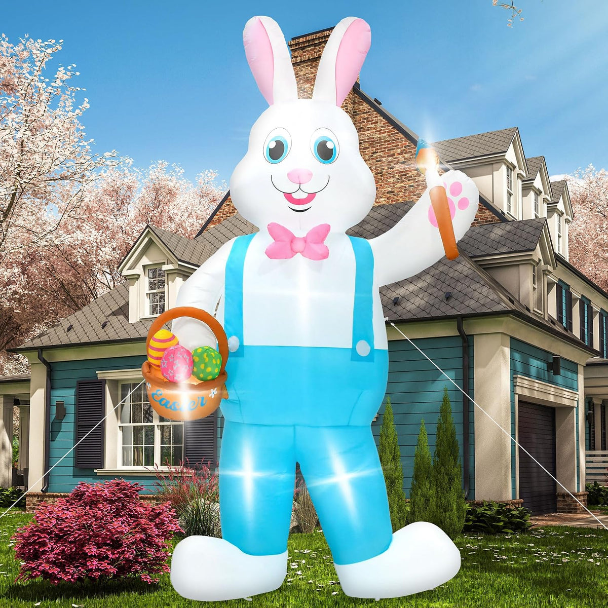 Tall white Easter bunny inflatable in blue overalls holding an egg basket in front of a house